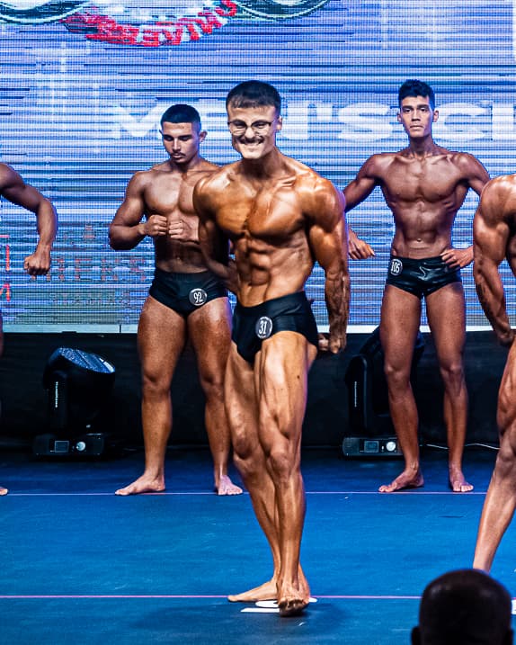 Maks competing on stage at the Mr. Universe European Championship